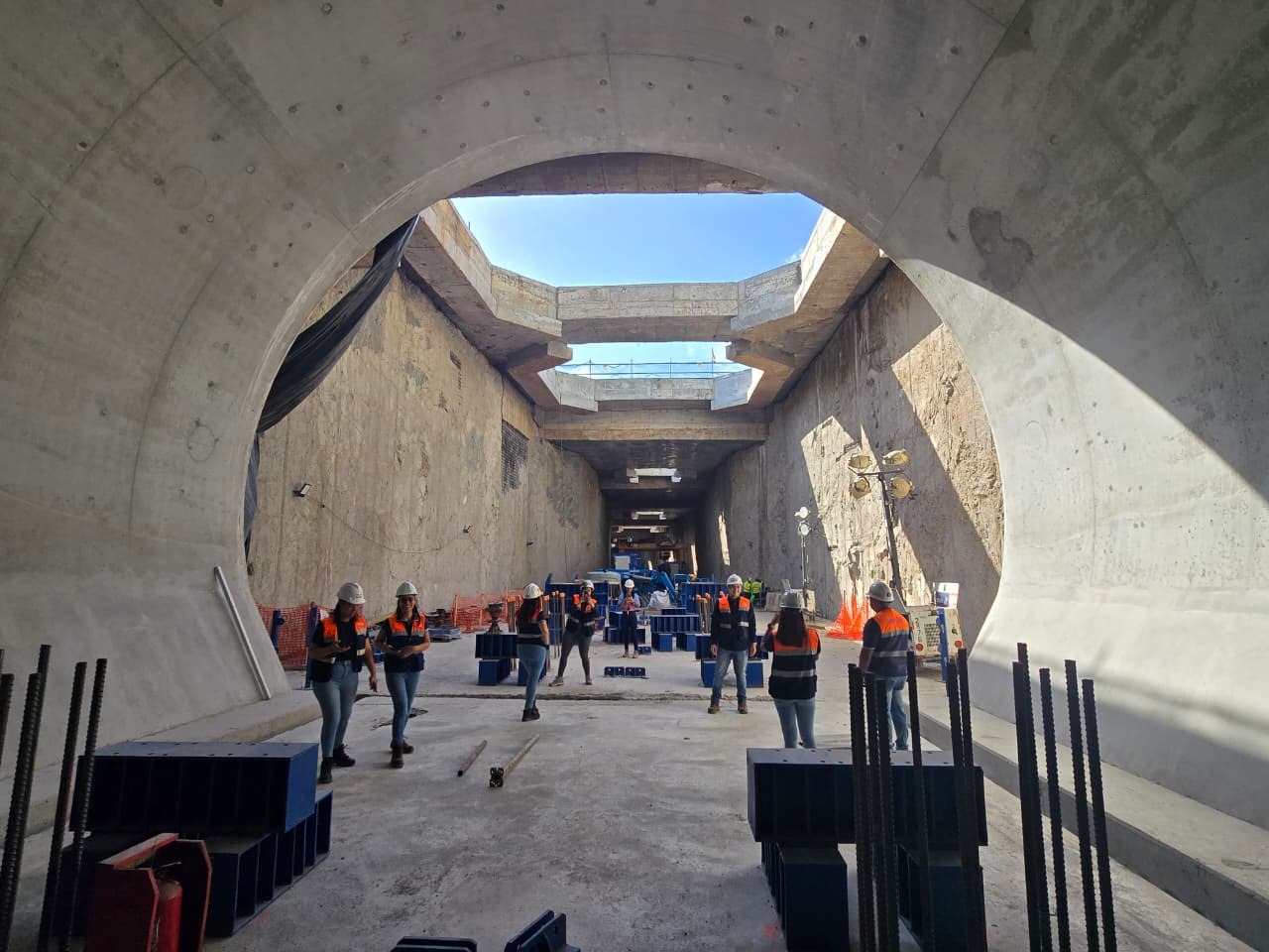 Boca del túnel abriendo a la caja de estación a cielo abierto, con la cuadrilla en obra